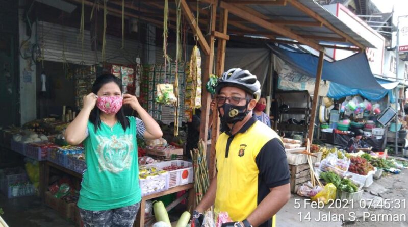 Foto saat Kapolsek Pahandut, Polresta Palangka Raya, Polda Kalteng Kompol Edia Sutaata bagikan masker dam imbau 3M